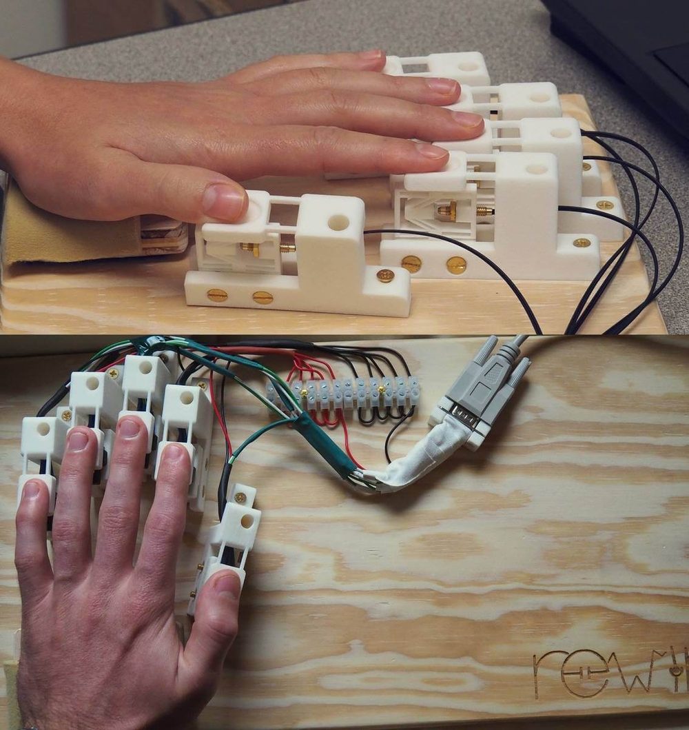 Two 3D-printed finger keyboards: the MRI-compatible optical version on top and the piezoelectric version below